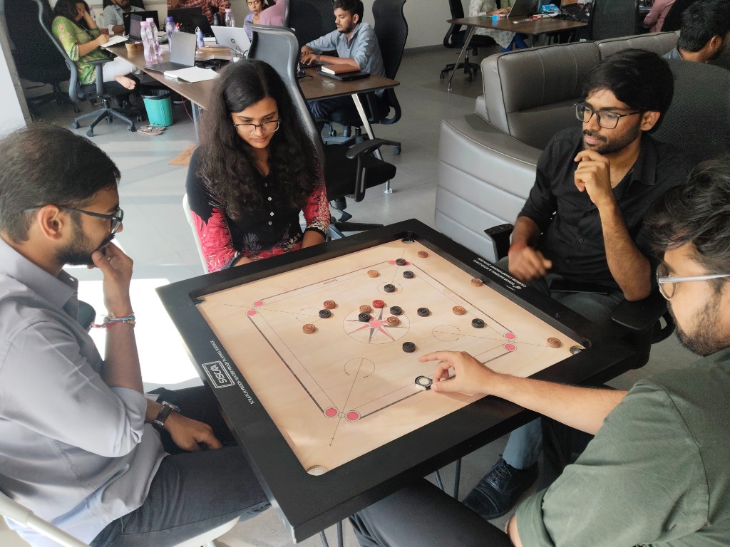 Team playing carrom in the office